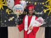 Proud graduate Brianna poses with a big smile after the ceremony, holding balloons and flowers lovingly gifted by her parents.