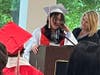 Eighth-grade graduate Leilah delivers a heartfelt speech, thanking her parents for always being there for her and supporting her, as Kennedy School teacher Jackie DeMarco stands proudly by her side. 