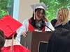Eighth-grade graduate Leilah delivers a heartfelt speech, thanking her parents for always being there for her and supporting her, as Kennedy School teacher Jackie DeMarco stands proudly by her side. 