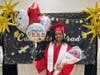 Proud graduate Brianna poses with a big smile after the ceremony, holding balloons and flowers lovingly gifted by her parents.