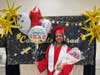 Proud graduate Brianna poses with a big smile after the ceremony, holding balloons and flowers lovingly gifted by her parents.