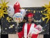 Proud graduate Brianna poses with a big smile after the ceremony, holding balloons and flowers lovingly gifted by her parents.