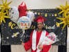 Proud graduate Brianna poses with a big smile after the ceremony, holding balloons and flowers lovingly gifted by her parents
