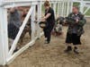 Debbie Macenas, Activity/Production Assistant at St. Coletta’s of Illinois, joins participants Billy and Scott as they feed the pigs at Navarro Farm in Frankfort. 