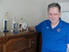 Jerry stands proudly beside his collection of bowling trophies, now displayed on the dresser in his bedroom at St. Coletta’s Intermediate Care Facility—a reminder of his many accomplishments and lifelong love of the sport. 