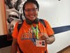 Camille shows off her new Shepherds College ID badge with a big smile—an official student and a true trailblazer as Kennedy School’s first graduate to attend college.