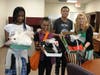 Transition Town students at Kennedy School deliver their hand-curated “Personally Styled Fashion” boxes to staff, alongside special education teacher Leslie Chowaniec, who guides them through the project. 