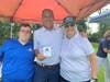 A golfer celebrates “Beating the Nun” with Sister Maryann Dosen and Billy from St. Coletta’s Community Day Services program.