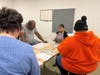 Bakery Manager Elsa Espinosa Diaz reviews workplace expectations with participants in St. Coletta’s Bakery Job Training Program, emphasizing professionalism, personal hygiene and the importance of treating the bakery as a real job.