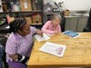Deareo and Ronna, participants in St. Coletta’s Bakery Job Training Program, review program paperwork as they begin their four-week training focused on building workplace skills and preparing for paid employment.