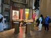 Shalini Kumar reads about Carlo Acutis at a shrine dedicated to the young saint inside the Cathedral of San Rufino during a Franciscan pilgrimage to Assisi. 