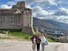 Shalini Kumar, Charla Brautigam, and Meredith O’Brien stand atop Rocca Maggiore, taking in the sweeping views of Assisi during their 10-day Franciscan pilgrimage to Italy. 
