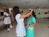 A crowning moment for Jesna J., who beams with pride as an Andrew High School student places the tiara on her head – officially naming her Prom Queen.