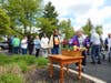 Ronna, a participant in St. Coletta’s Community Day Services program, places a flower in the basket beneath the Blessed Mother statue during St. Coletta’s annual May Crowning celebration.