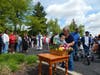 St. Coletta’s Board member Julie Shellberg helps a young child place his flower in the basket beneath the Blessed Mother statue during the organization’s annual May Crowning celebration.