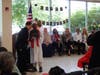 A proud milestone moment! An eighth-grade Kennedy School graduate accepts his certificate of completion during the May 20 graduation ceremony as his teachers look on with smiles and pride, celebrating all he has accomplished.