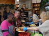 Veronica and Selena smile as they make their selections from a picnic spread prepared and served by volunteers from All Saints Lutheran Church.