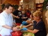 Xavier and Kevin, participants in St. Coletta’s Community Day Services program, select their picnic favorites as volunteers from All Saints Lutheran Church serve lunch during the first Summer Picnic of the season on June 16.