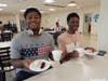 Two students get ready to enjoy their cake and ice cream sundaes.