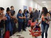 Teacher Tasheka Klimczak leads a student behind the wheel of a Lightning McQueen-inspired box car through the halls of Kennedy School as classmates and staff cheer, clap and offer high-fives during the school’s first-ever Box Car Parade.