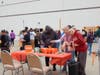 A volunteer from All Saints Lutheran Church explains how to play Poke-a-Pumpkin to two participants from St. Coletta’s Community Day Services program. 
