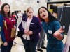A young adult explaining about the poster to Kristin Schroeder, Humanities Teacher​ from Western Sierra Collegiate Academy  