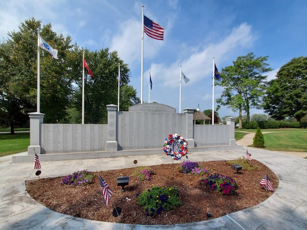 Flags fly majestically at the Enfield War Memorial. Today, Gov. Ned Lamont ordered all flags in Connecticut to fly at half-staff to remember the 1 million dead from the Covid-19 pandemic nationally.