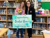 Bridget Krauss, Parent of the Year for the Milford Public Schools, left, didn’t know what was happening when she was conducting the PTA Meeting one evening last week.  Milford school chief Anna Cutaia, right, surprised her with the honor.