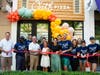 Town and corporate dignitaries, including West Hartford Mayor Shari Cantor, cut a ribbon Thursday to celebrate the official opening of Oath Pizza in Blue Back Square.