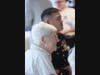 Avery Heights resident and former master sergeant William Cronin, 92, a Marine Corps Korean War veteran, sits with a uniformed U.S. marine during the event.