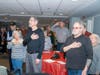 Plainville Senior Center members along with the rest of the audience stand to recite the
Pledge of Allegiance at a special ceremony at The Orchards in Southington March 29 commemorating the end of the Vietnam War.