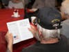 A veteran on hand at last week's special ceremony in Southington reads the event's program.