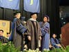 University of Saint Joseph Provost Michelle Kalis, left, and USJ President Rhona Free, right, present commencement speaker Bruce Mandell, center, with an honorary doctorate.