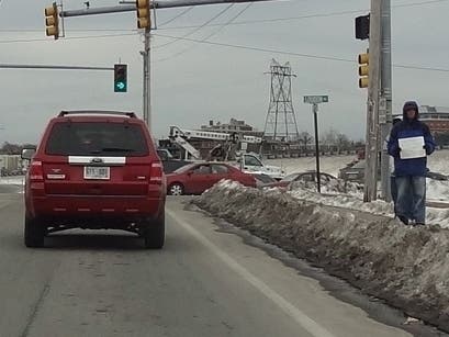 A panhandler in Concord, N.H., seeks help from motorists in this Patch file photo. Southington officials recently announced an education campaign aimed at helping panhandlers in that town as opposed to legislating against the practice.