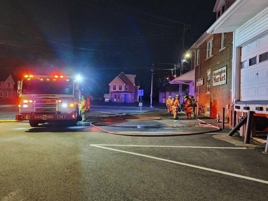 Firefighters tend to the scene of an early morning blaze at the Kensington Market in Berlin early Saturday morning. The popular store will be closed for weeks due to the damage.