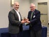 Southington resident Dan Daigle left, accepts the gavel from prior Main Street Community Foundation Chairman Scott Fournier, right.
