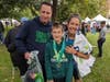 West Hartford teacher and Bristol resident Margo Parenti, right, started running after her young son died. Here, she celebrates running in the 2023 Hartford Half Marathon with her husband Robert Parenti, left, and son Alexander Parenti, 13, center.
