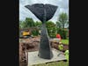 Workers scramble Wednesday, May 29, to erect a statue featuring the tail of the beloved 'Conny the Whale' in West Hartford.