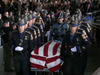 Troopers solemnly bring fallen Trooper First Class Aaron Pelletier's casket into the Xfinity Theater in Hartford during his funeral Wednesday.
