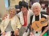 Middlewoods of Farmington residents, Rose Pane, left, and Muriel Masse, right, pose for a photo with maintenance director, Michael LaMere, who was dressed as Elvis, for a surprise appearance during the community’s recent “Elvis Week” event.
