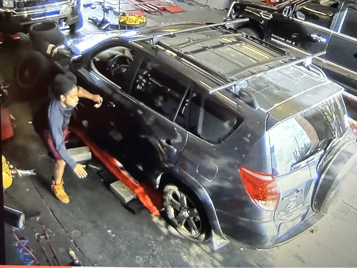 Suspect Mike Alexander-Garcia enters a Toyota Rav4 inside a Town Fair Tire garage in West Hartford on Aug. 8, 2023. At the time, he was fleeing West Hartford police after a car crash involving a stolen vehicle. He was shot and killed by a WHPD officer.
