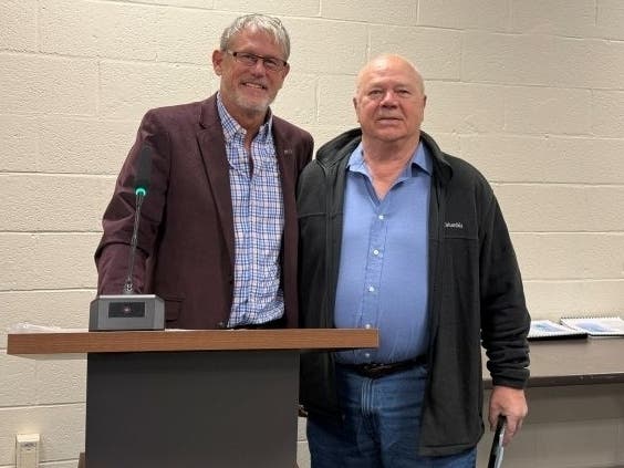 Canton First Selectman Kevin Witkos, left, announced the dedication of the 2024-25 annual report to local fuel bank advocate and community servant Michael A. Langer, right.
