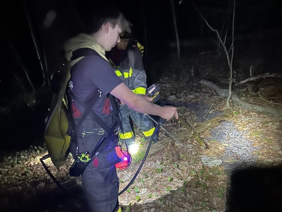 Avon firefighters recently had to hike into a heavily wooded area to extinguish a campfire that evolved into a brush fire, prompting the department to issue a brush fire warning on Tuesday.