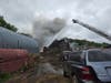 Firefighters had to utilize ladder trucks to get above the flames during Saturday's battle against a massive inferno at a Southington junkyard.