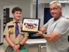 Former Sedgwick student Desmond McGloin, now a ninth-grader at Conard High School and current Eagle Scout, left, receives a plaque from Sedgwick physical education teacher Steven Garneau for McGloin's scout project that provided handmade cornhole boards.