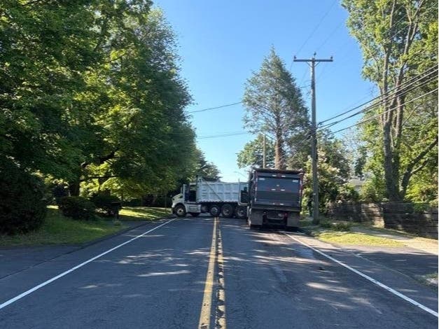 Two dump trucks and a school bus collided on North Main Street in West Hartford Thursday morning.