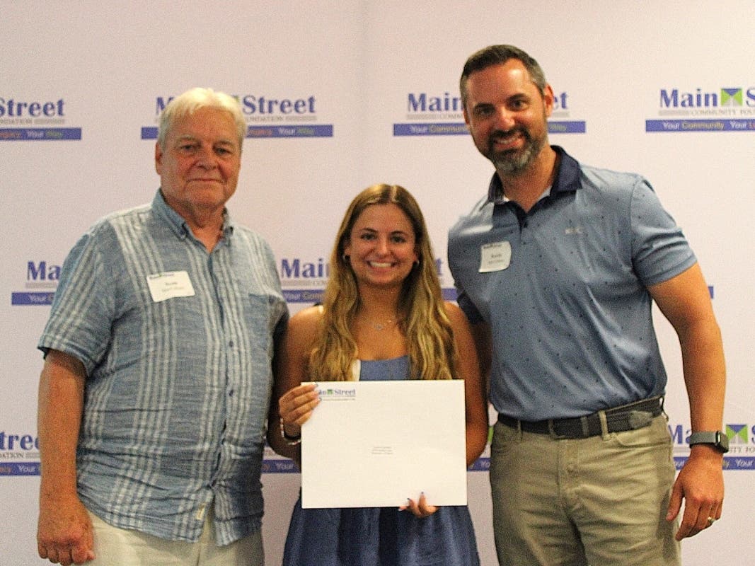 Southington resident Lauren Carrubba receives the Therese MacCallum 'Great Kid Scholarship' from Scott and Kevin MacCallum, Therese’s husband and son.