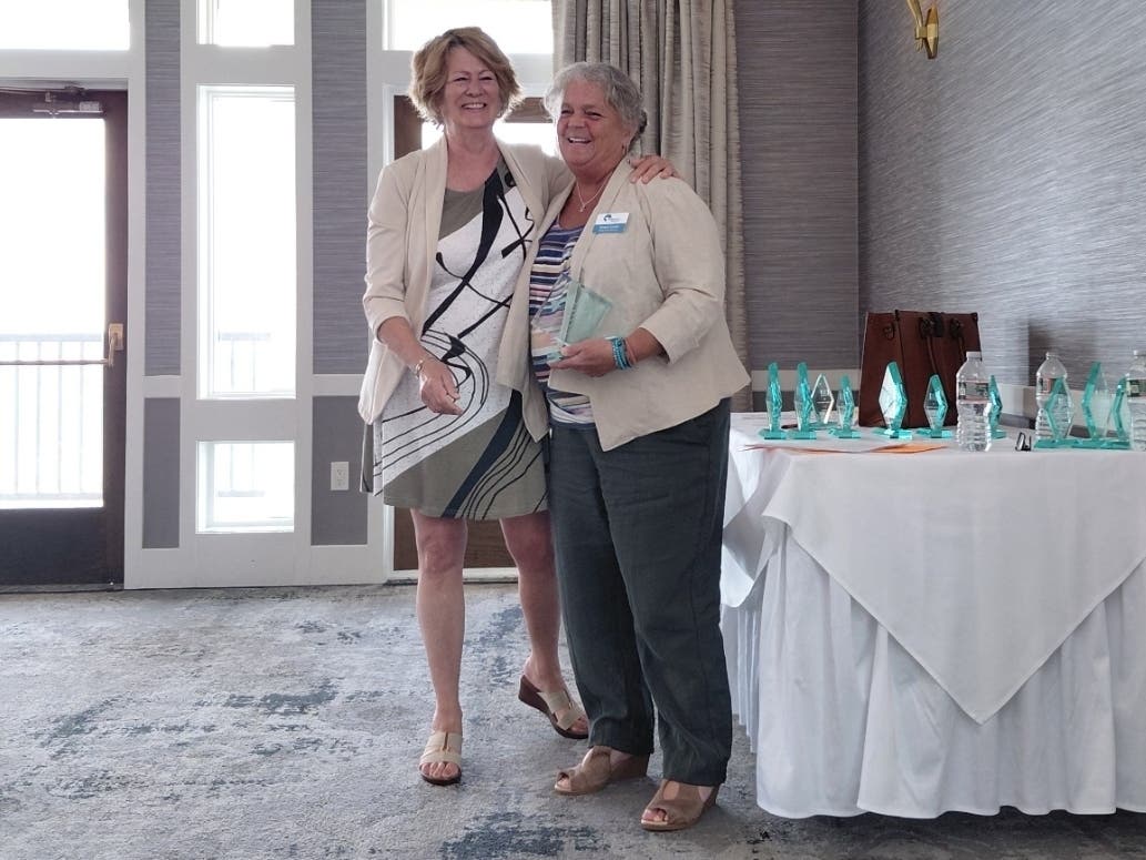 Nancy Lewis, a culinary server at Skybrooke at Simsbury, right, has been recognized by the Connecticut Assisted Living Association with its 2026 Outstanding Resident Service Award.
