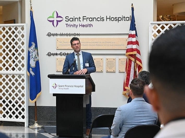 Dr. Robert Roose, president of acute care at Trinity Health of New England, speaks to colleagues and guests at a press conference at Saint Francis Hospital on Wednesday.
