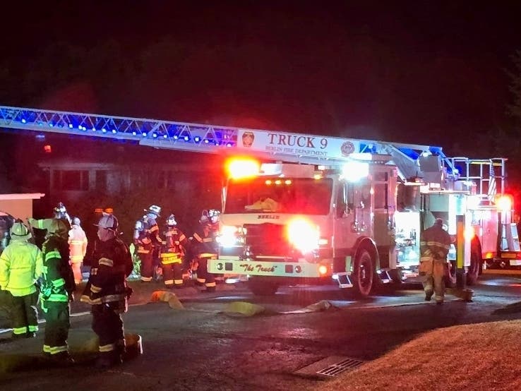 Three residents were taken to a hospital after an early-morning house fire Wednesday in Berlin. Above, firefighters swarm the scene.